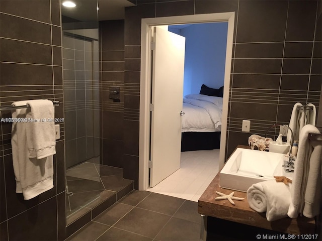 bathroom featuring tile patterned flooring and tiled shower