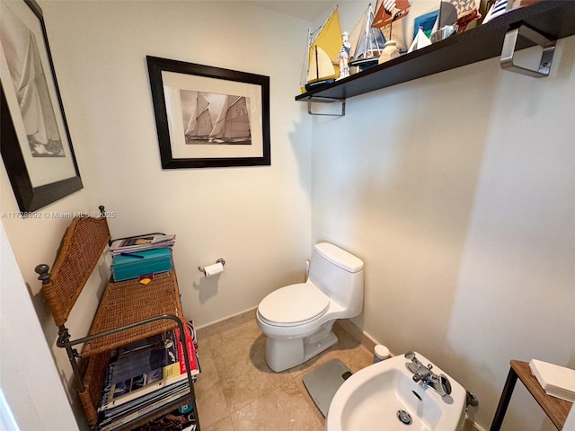 bathroom featuring toilet, tile patterned flooring, a bidet, and sink