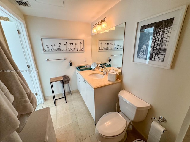 bathroom featuring toilet, tile patterned flooring, and vanity