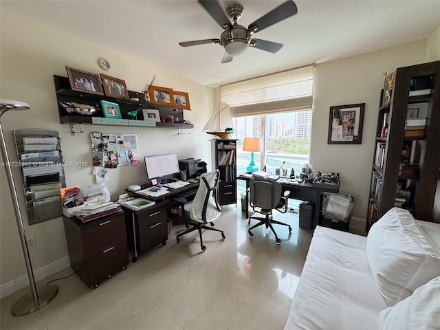 tiled office space featuring ceiling fan