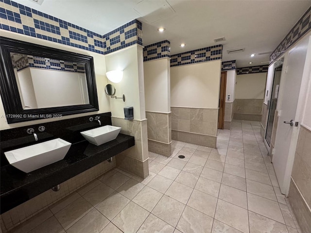 bathroom with sink, tile walls, and tile patterned floors