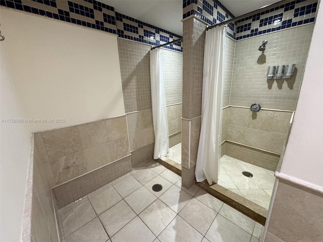 bathroom featuring tile walls, tile patterned floors, and curtained shower