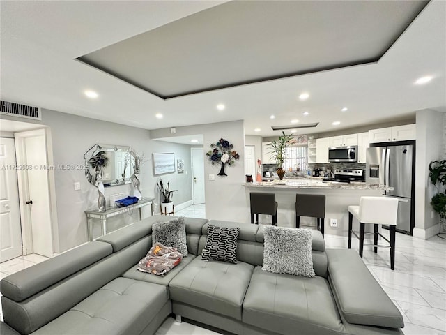 living room featuring a tray ceiling