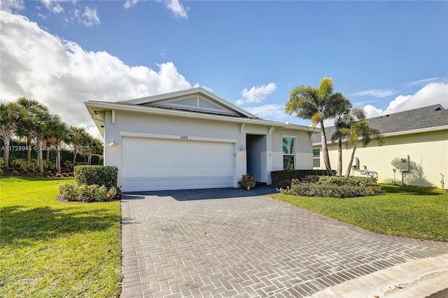 single story home with a garage and a front lawn