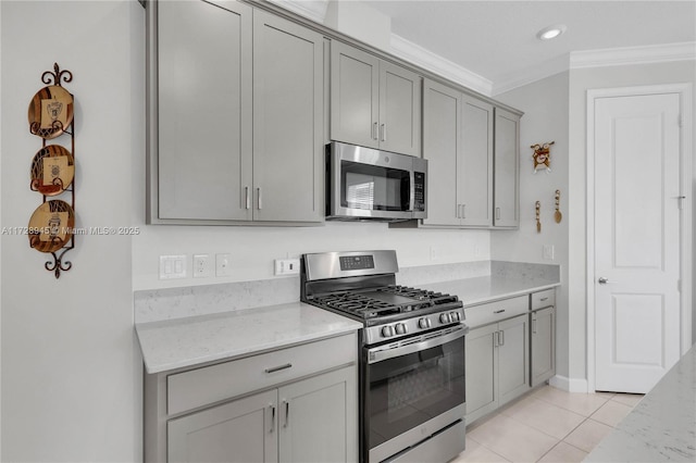 kitchen with light stone counters, crown molding, stainless steel appliances, and light tile patterned flooring