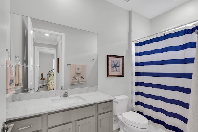 bathroom with curtained shower, toilet, vanity, and ornamental molding