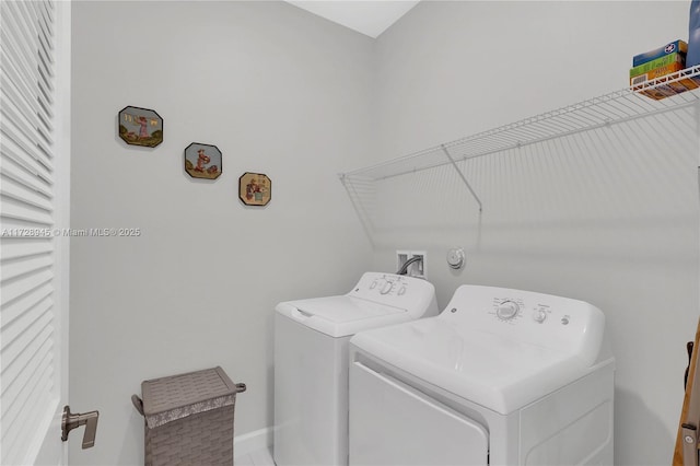 clothes washing area featuring independent washer and dryer