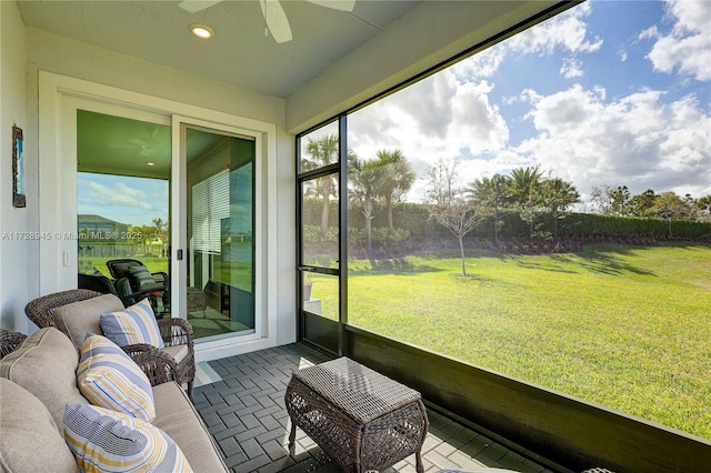 sunroom featuring ceiling fan