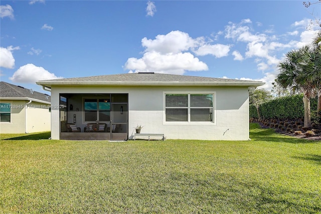 back of house with a yard and a sunroom