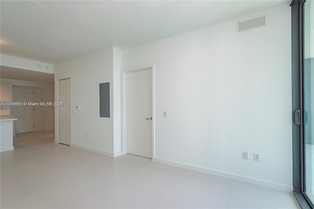 unfurnished room featuring electric panel