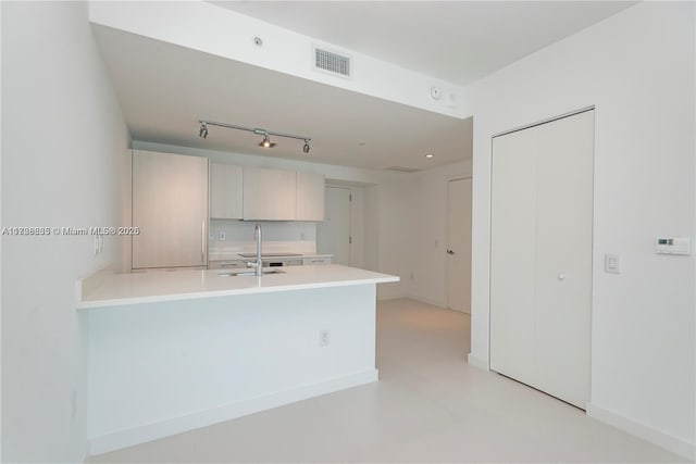 kitchen featuring kitchen peninsula and sink