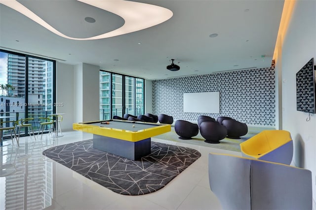 game room featuring billiards, tile patterned flooring, and floor to ceiling windows