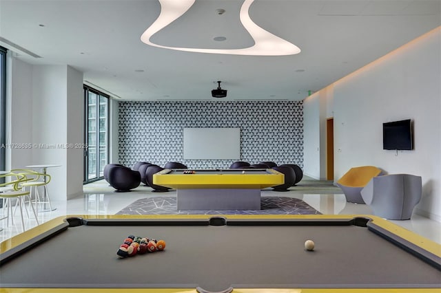 recreation room featuring a wall of windows and pool table