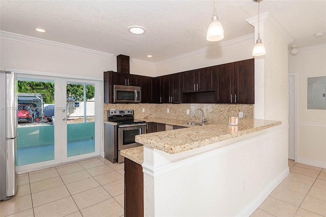 kitchen with kitchen peninsula, stainless steel appliances, decorative backsplash, decorative light fixtures, and sink