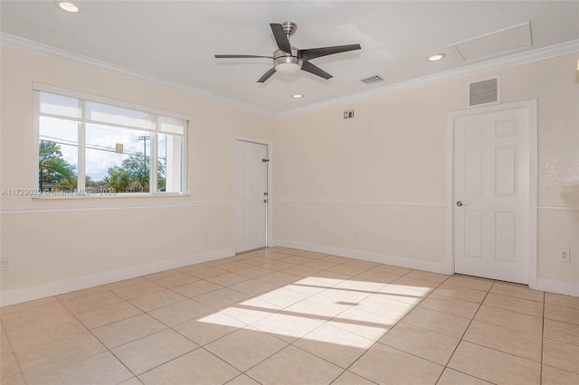 tiled empty room featuring ceiling fan and crown molding