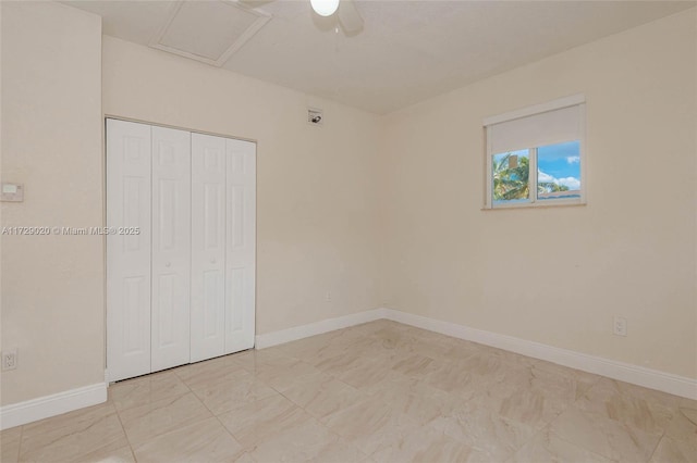 unfurnished bedroom featuring ceiling fan and a closet