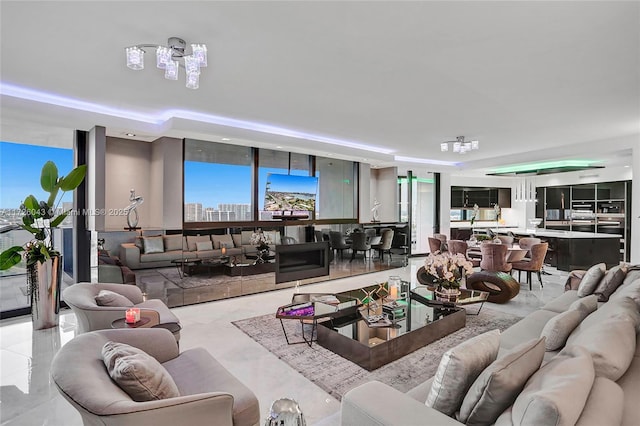 living room with a raised ceiling and expansive windows