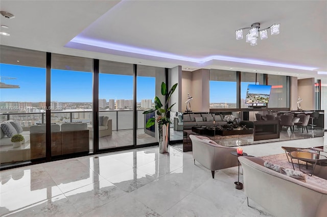 interior space featuring expansive windows and a raised ceiling