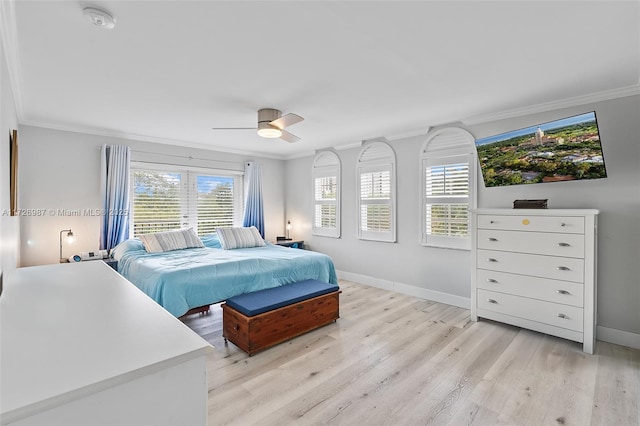 bedroom featuring light wood-type flooring, baseboards, ornamental molding, and a ceiling fan