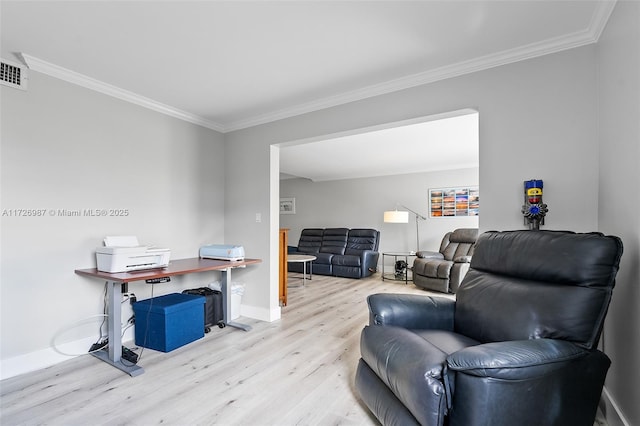 living area with light wood finished floors, baseboards, and ornamental molding