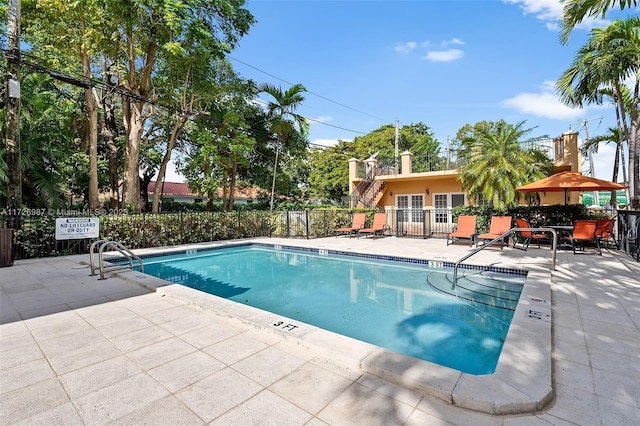 pool with a patio area, fence, a gazebo, and stairs