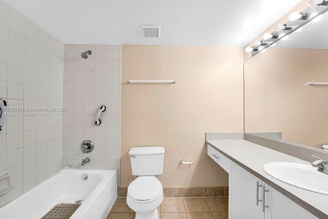 full bathroom with toilet, vanity, tiled shower / bath, and tile patterned flooring