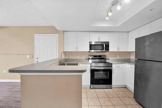 kitchen featuring white cabinets, stainless steel appliances, sink, kitchen peninsula, and light tile patterned flooring