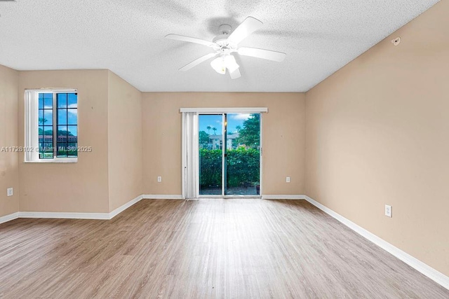 empty room featuring ceiling fan, a textured ceiling, and light wood-type flooring