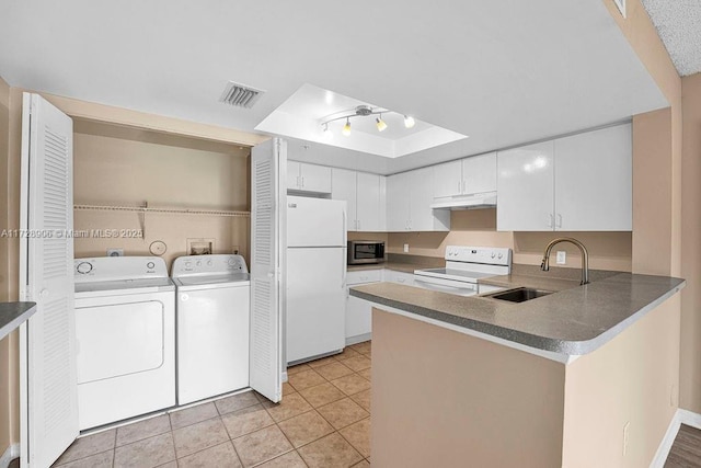 kitchen featuring kitchen peninsula, sink, white appliances, white cabinetry, and separate washer and dryer