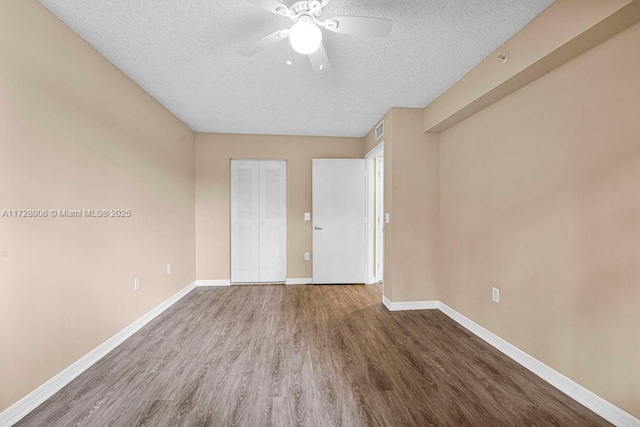 spare room featuring a textured ceiling, ceiling fan, and hardwood / wood-style floors