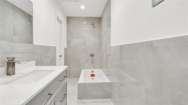 bathroom with tile walls and vanity