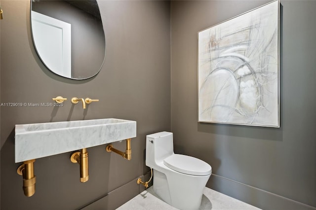 11001 SW 74th Ave, Pinecrest, FL 33156 - half bathroom featuring toilet, a sink, and baseboards