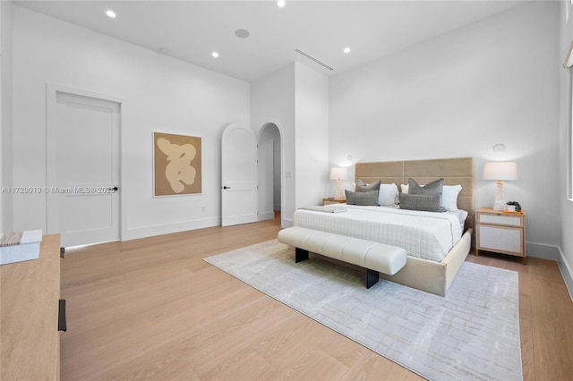 11001 SW 74th Ave, Pinecrest, FL 33156 - bedroom featuring arched walkways, light wood-style floors, baseboards, and recessed lighting