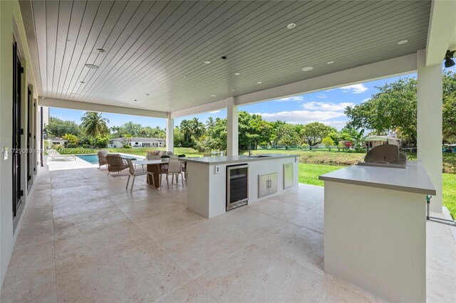 11001 SW 74th Ave, Pinecrest, FL 33156 - view of patio featuring wine cooler and an outdoor pool