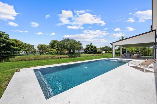 11001 SW 74th Ave, Pinecrest, FL 33156 - view of swimming pool with a patio, a lawn, and a pool with connected hot tub