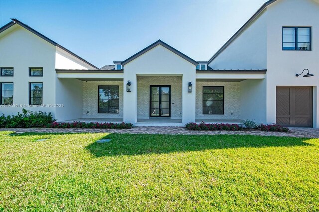 11001 SW 74th Ave, Pinecrest, FL 33156 - view of front of house featuring a front lawn, stucco siding, and a porch