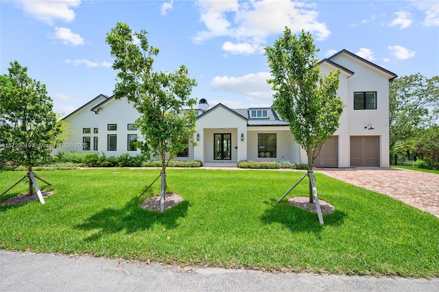 11001 SW 74th Ave, Pinecrest, FL 33156 - modern farmhouse style home with a garage, driveway, a front yard, stucco siding, and a standing seam roof