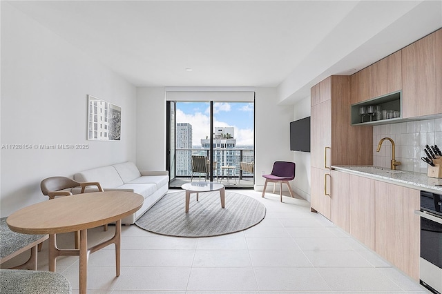 living room with sink and light tile patterned floors