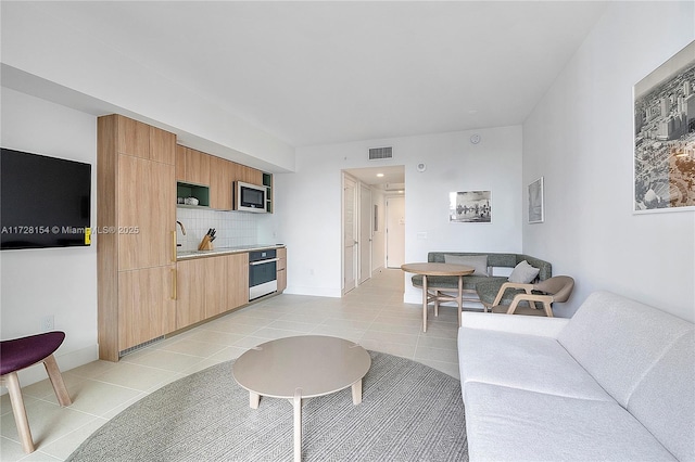 tiled living room featuring sink