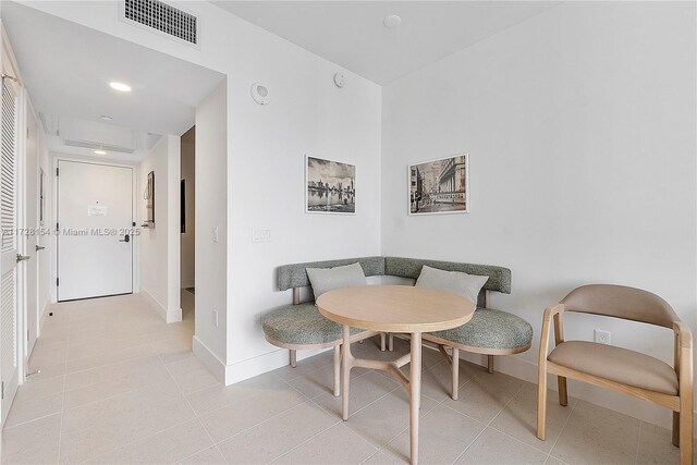 dining room featuring breakfast area and light tile patterned flooring