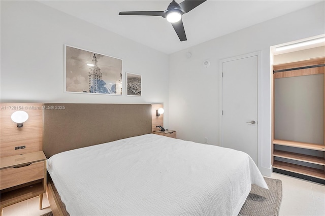 bedroom featuring a closet, ceiling fan, and light tile patterned floors