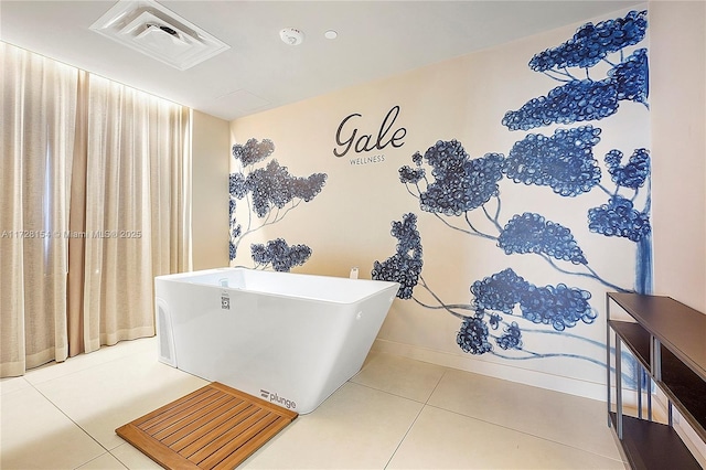 bathroom with tile patterned flooring and a bathtub