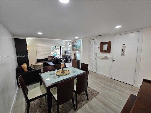 dining space with light hardwood / wood-style floors