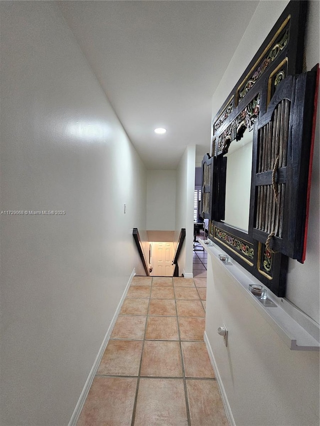 hall with light tile patterned floors