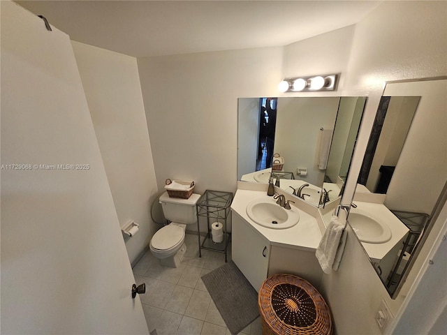 bathroom featuring vanity, tile patterned floors, and toilet