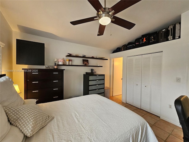 tiled bedroom featuring lofted ceiling, a closet, and ceiling fan