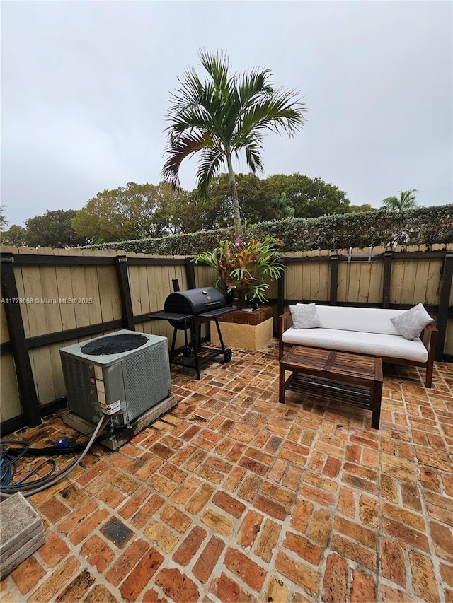 view of patio / terrace featuring cooling unit and a grill