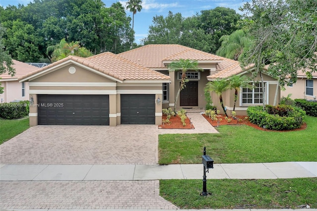 view of front of property with a garage and a front yard