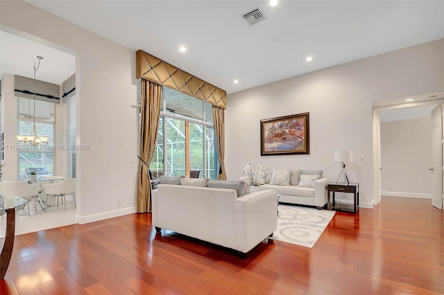 living room featuring hardwood / wood-style flooring and a chandelier