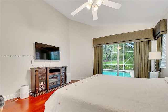 bedroom with hardwood / wood-style flooring, ceiling fan, lofted ceiling, and access to exterior